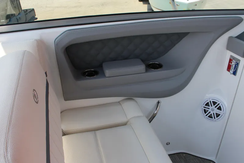Slide: The Image of Interior of a 2018 Cobalt R35 boat featuring white seating and cup holders. - 30