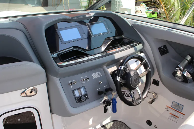 Slide: The Image of 2018 Cobalt R35 boat dashboard with dual screens and modern steering wheel. - 31