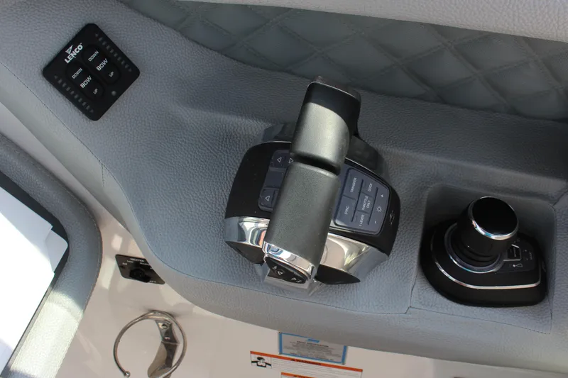 Slide: The Image of Control panel of a 2018 Cobalt R35 boat with joystick and trim tab controls. - 35