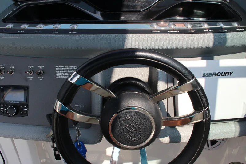 Slide: The Image of Steering wheel and dashboard of 2018 Cobalt R35 boat with Mercury controls. - 36