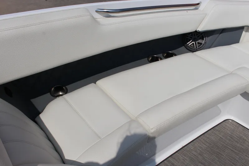 Slide: The Image of 2018 Cobalt R35 boat interior with white cushioned seating and cup holders. - 46