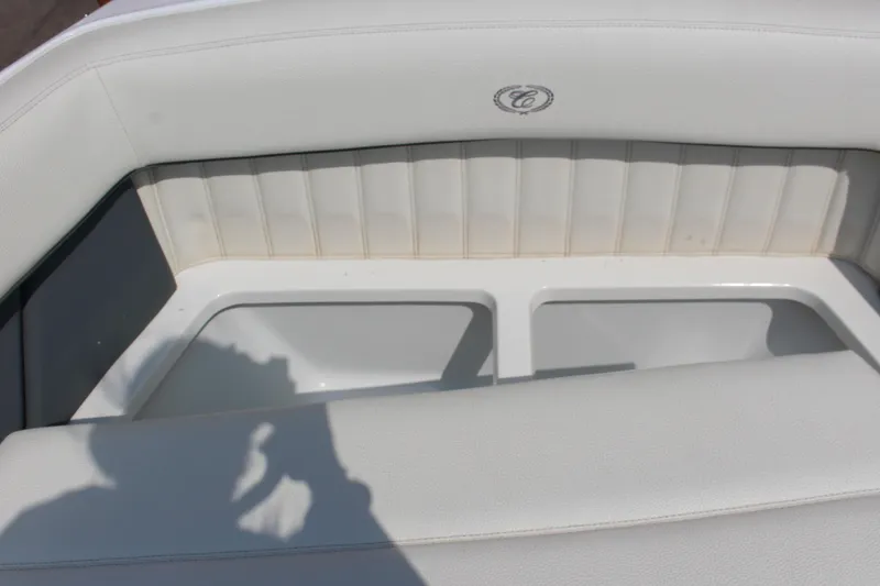 Slide: The Image of 2018 Cobalt R35 boat interior with white cushioned seating and storage compartment. - 49