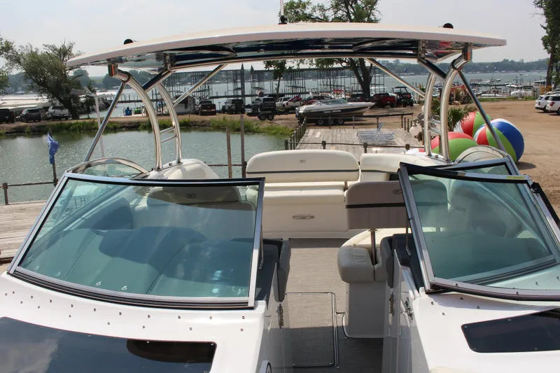Slide: The Image of 2018 Cobalt R35 boat with spacious seating, docked by a scenic waterfront. - 54