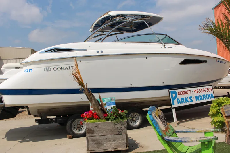 Slide: The Image of 2018 Cobalt R35 boat displayed at Parks Marina with vibrant flowers and a colorful chair. - 61