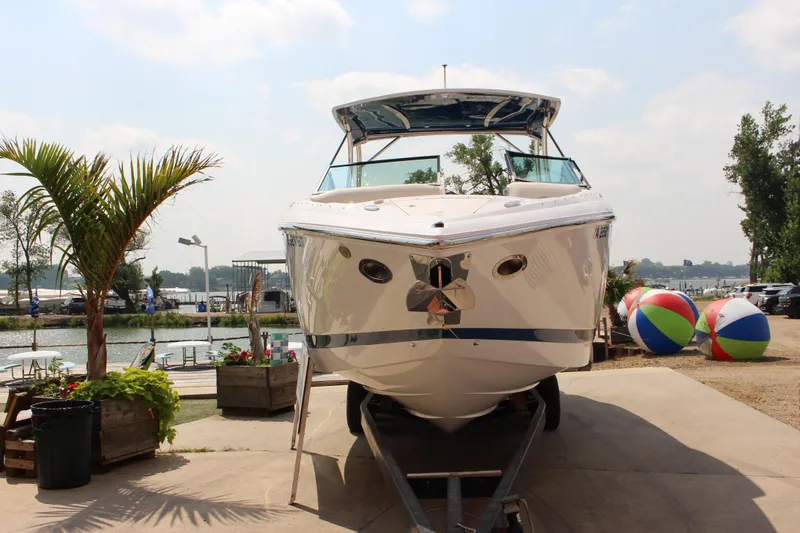 Slide: The Image of 2018 Cobalt R35 boat on trailer by waterfront, surrounded by palm trees and beach balls. - 62