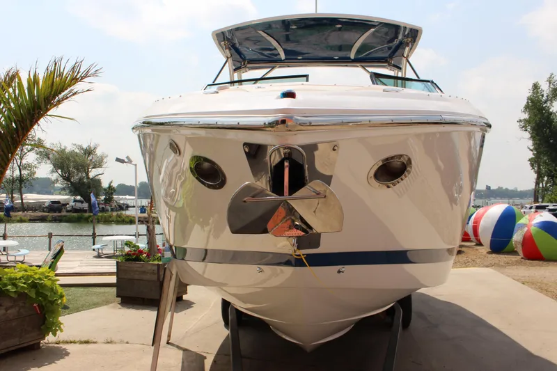 Slide: The Image of Front view of a 2018 Cobalt R35 boat docked by a lakeside. - 63