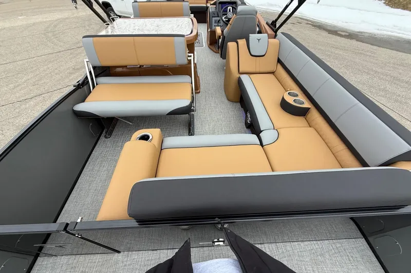 Slide: The Image of Luxurious 2025 Tahoe 2785 boat interior with tan and gray seating, cup holders, and modern design. - 10