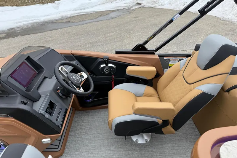 Slide: The Image of Captain's seat and dashboard of 2025 Tahoe 2785 boat, featuring modern controls and luxurious design. - 13