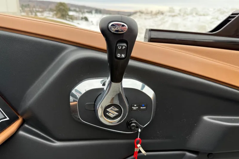 Slide: The Image of 2025 Tahoe 2785 boat throttle control with Suzuki logo and key ignition. - 18