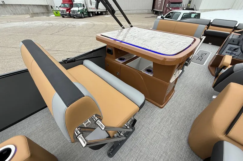 Slide: The Image of Luxurious interior of 2025 Tahoe 2785 boat with tan seating and sleek table design. - 20
