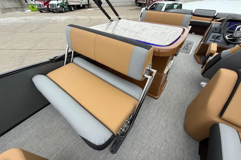 Slide: The Image of 2025 Tahoe 2785 boat interior with tan and gray seating, modern design. - 21