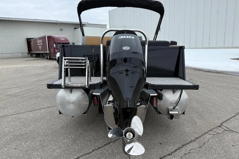 Slide: The Image of 2025 Tahoe 2785 boat with powerful outboard motor, parked on concrete surface. - 4