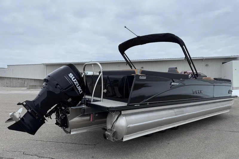 Slide: The Image of 2025 Tahoe 2785 pontoon boat with Suzuki outboard motor, parked outdoors. - 5