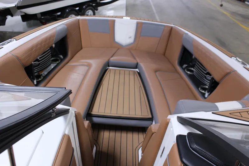 Slide: The Image of 2018 Nautique Super Air Nautique G25 interior with tan seating and wood accents. - 3