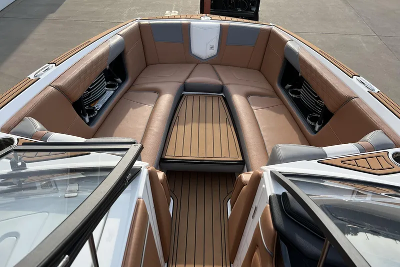 Slide: The Image of 2018 Nautique Super Air Nautique G25 interior with luxurious brown seating and wood accents. - 5