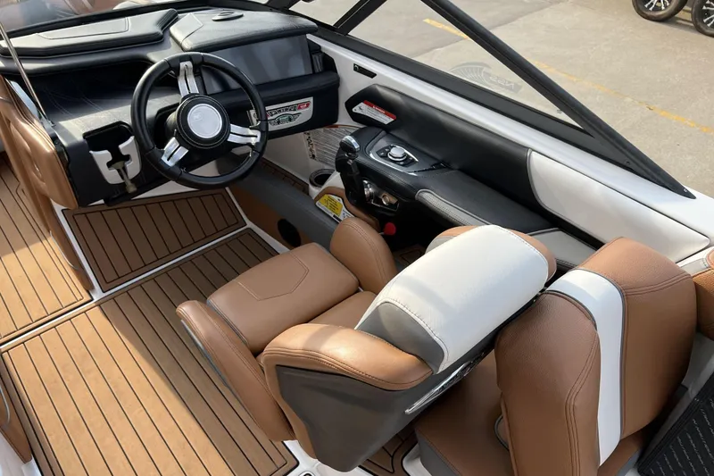 Slide: The Image of 2018 Nautique Super Air Nautique G25 interior with brown leather seats and steering wheel. - 6