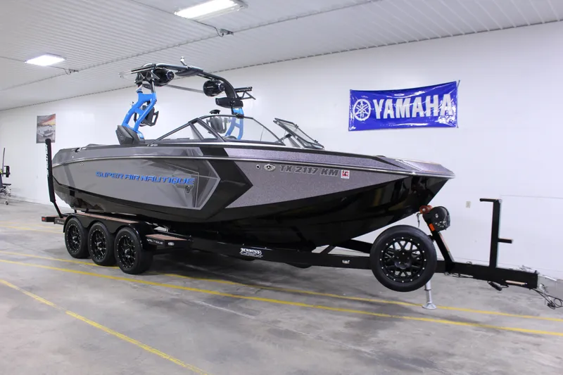 The Image of 2018 Nautique Super Air Nautique G25 boat on trailer in indoor showroom. - 1