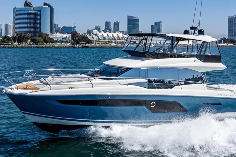 Slide: The Image of 2019 Prestige 520 yacht cruising near city skyline on a sunny day. - 1