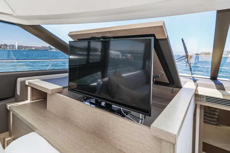 Slide: The Image of Luxurious 2019 Prestige 520 yacht interior with pop-up TV and ocean view. - 13