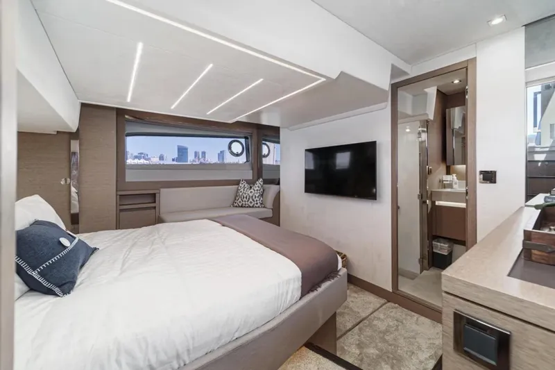 Slide: The Image of Luxurious 2019 Prestige 520 yacht bedroom with modern decor and city view. - 23