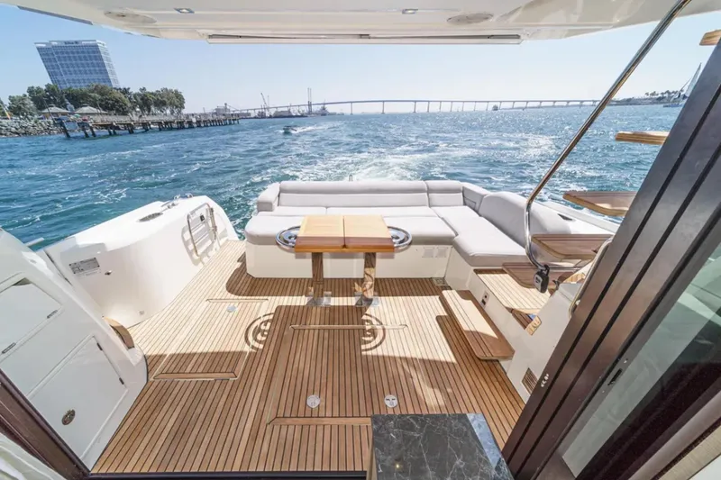 Slide: The Image of Luxurious 2019 Prestige 520 yacht deck with seating, table, and ocean view. - 25