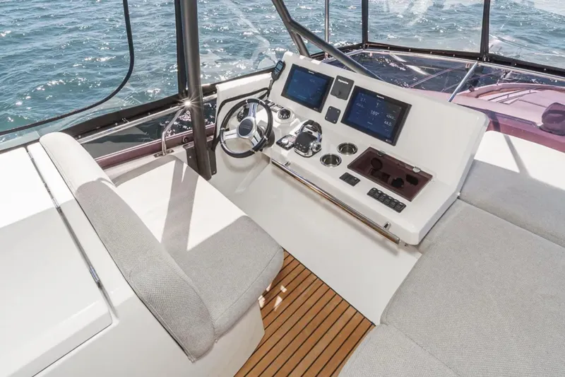 Slide: The Image of Helm station of 2019 Prestige 520 yacht with modern controls and ocean view. - 29