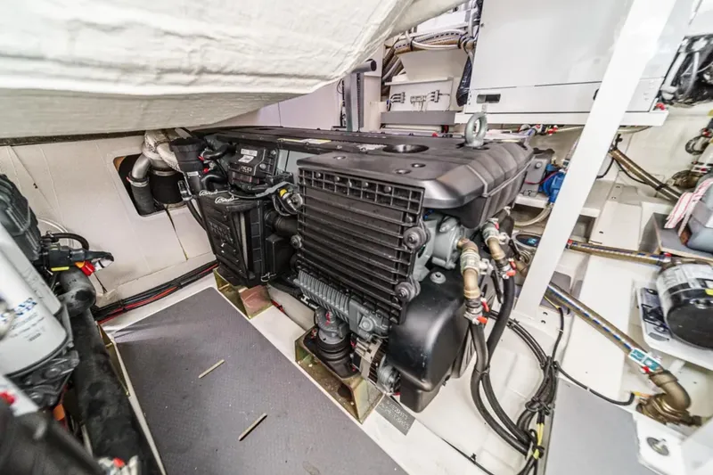 Slide: The Image of Engine room of a 2019 Prestige 520 yacht, showcasing detailed mechanical components. - 37