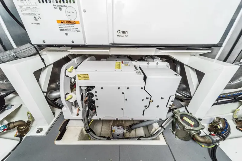 Slide: The Image of Engine room of a 2019 Prestige 520 yacht featuring an Onan generator. - 40