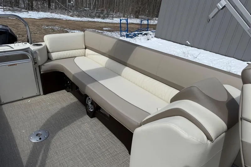 Slide: The Image of 2025 Tahoe 2585 boat interior with beige seating and carpeted floor. - 11