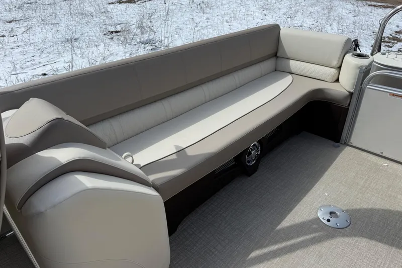 Slide: The Image of 2025 Tahoe 2585 boat interior with beige seating and carpeted floor. - 12