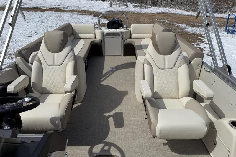 Slide: The Image of 2025 Tahoe 2585 boat interior with luxurious beige seating and steering wheel, set against a snowy backdrop. - 15