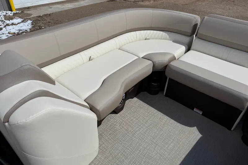 Slide: The Image of 2025 Tahoe 2585 boat interior with beige and white cushioned seating. - 20