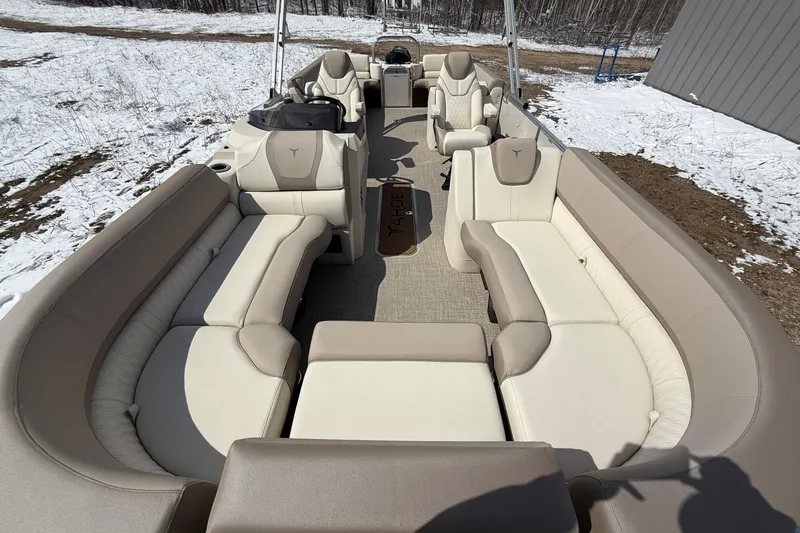 Slide: The Image of 2025 Tahoe 2585 pontoon boat interior with beige seating, snowy background. - 21