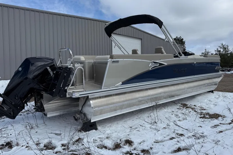 Slide: The Image of 2025 Tahoe 2585 pontoon boat with Mercury engine on snowy ground. - 3