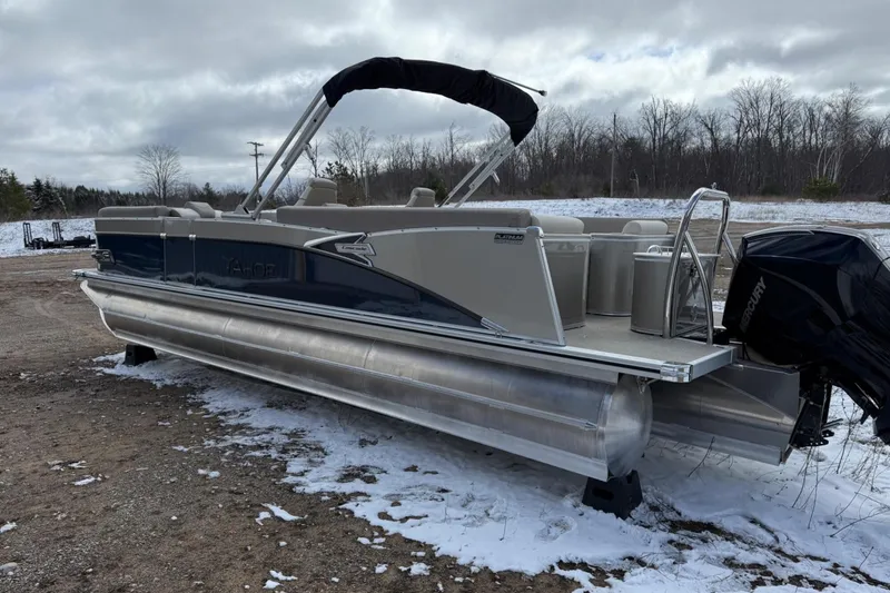 Slide: The Image of 2025 Tahoe 2585 pontoon boat on snowy ground, featuring sleek design and powerful outboard motor. - 7