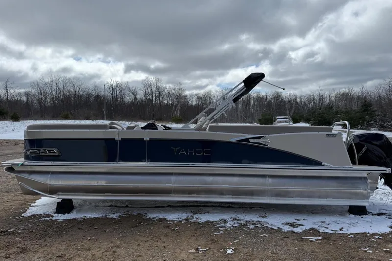 Slide: The Image of 2025 Tahoe 2585 pontoon boat on snowy ground, overcast sky, winter landscape. - 8
