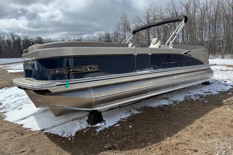 Slide: The Image of 2025 Tahoe 2585 pontoon boat on snowy ground, surrounded by bare trees. - 9