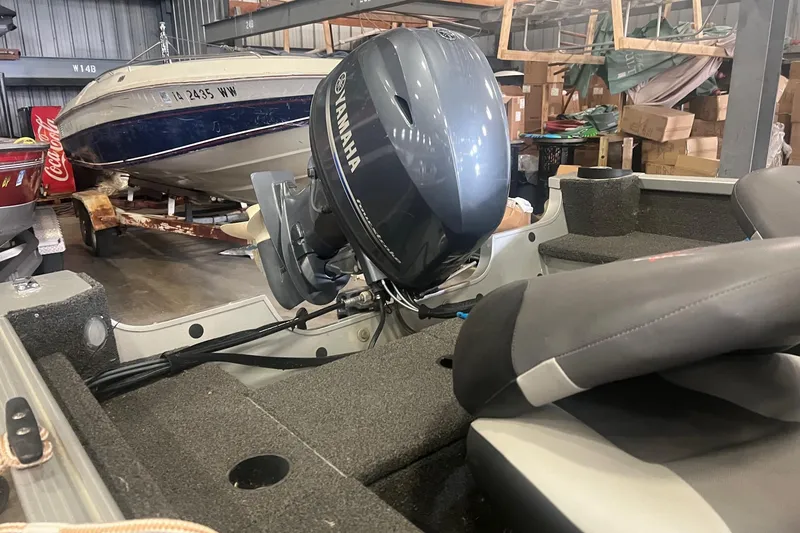 Slide: The Image of 2017 Alumacraft 165 boat with Yamaha outboard motor in storage facility. - 5