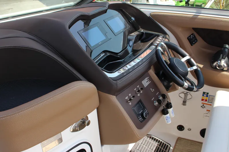 Slide: The Image of 2017 Cobalt R35 boat dashboard with steering wheel and digital displays. - 13