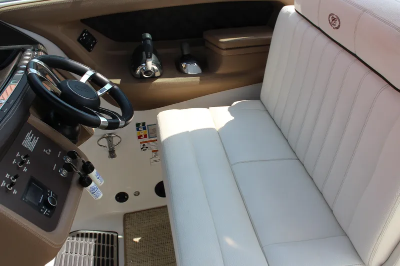 Slide: The Image of 2017 Cobalt R35 boat interior with white leather seating and steering wheel. - 14