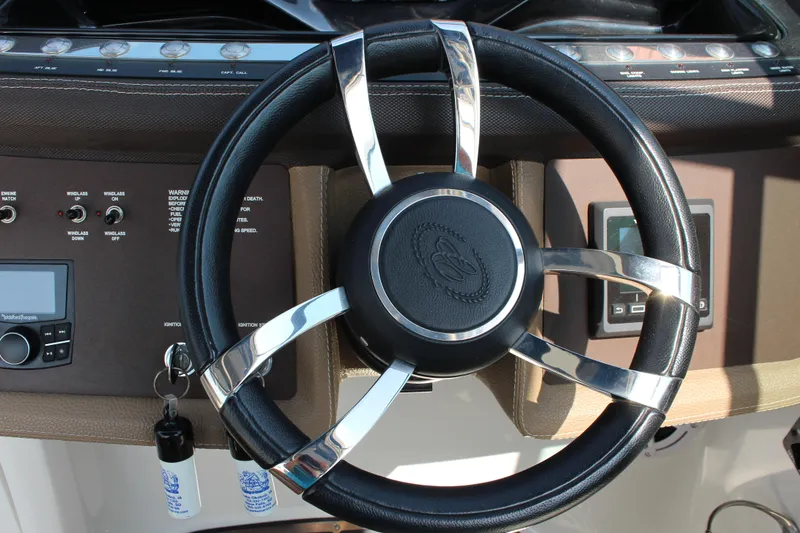 Slide: The Image of Steering wheel of a 2017 Cobalt R35 boat, featuring sleek chrome accents. - 16