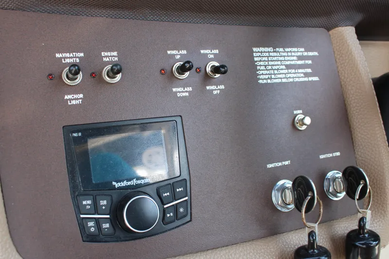 Slide: The Image of Control panel of a 2017 Cobalt R35 boat with switches and Rockford Fosgate audio system. - 18