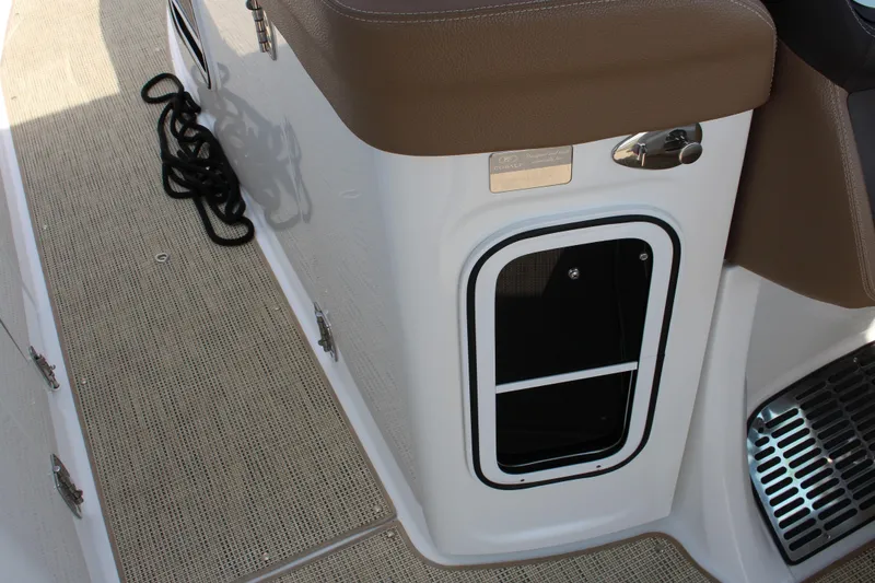 Slide: The Image of Cobalt R35 2017 boat interior with storage compartment and brown seating. - 21