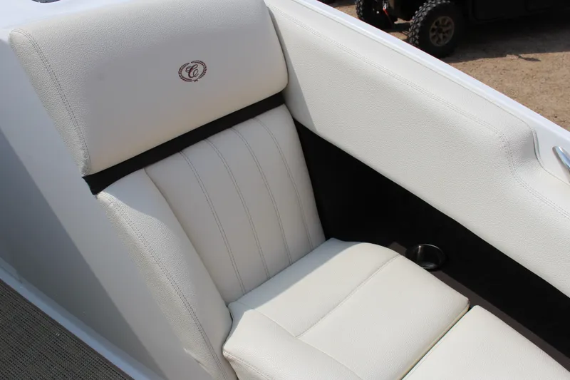 Slide: The Image of White leather seat in 2017 Cobalt R35 boat, featuring elegant stitching and logo. - 24