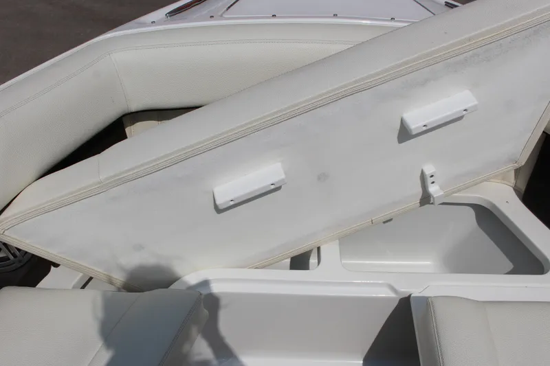 Slide: The Image of 2017 Cobalt R35 boat interior storage compartment with open cushioned seat. - 25