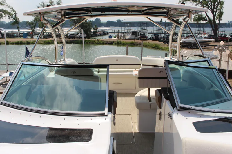 Slide: The Image of 2017 Cobalt R35 boat with open cockpit, docked by a scenic waterfront. - 28