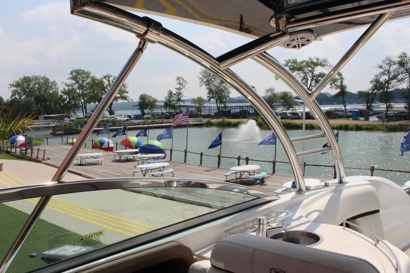 Slide: The Image of 2017 Cobalt R35 boat docked by a scenic waterfront with colorful umbrellas. - 32