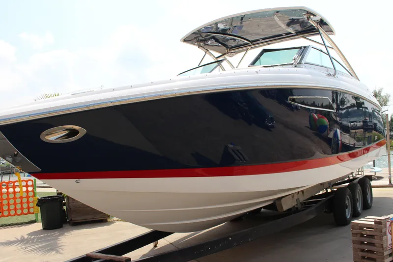 Slide: The Image of 2017 Cobalt R35 boat on trailer, sleek design with blue and red accents. - 37