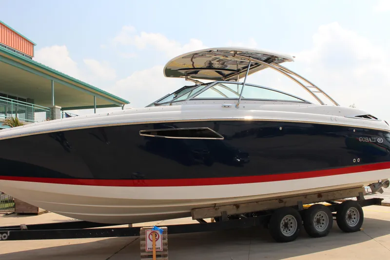 Slide: The Image of 2017 Cobalt R35 boat on trailer, sleek design with blue and white exterior. - 38