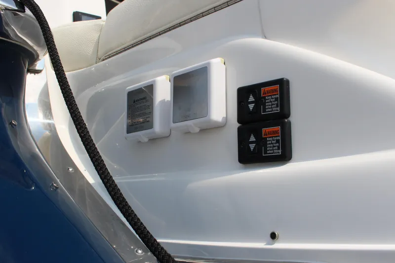 Slide: The Image of 2017 Cobalt R35 boat controls and warning labels on white panel. - 44